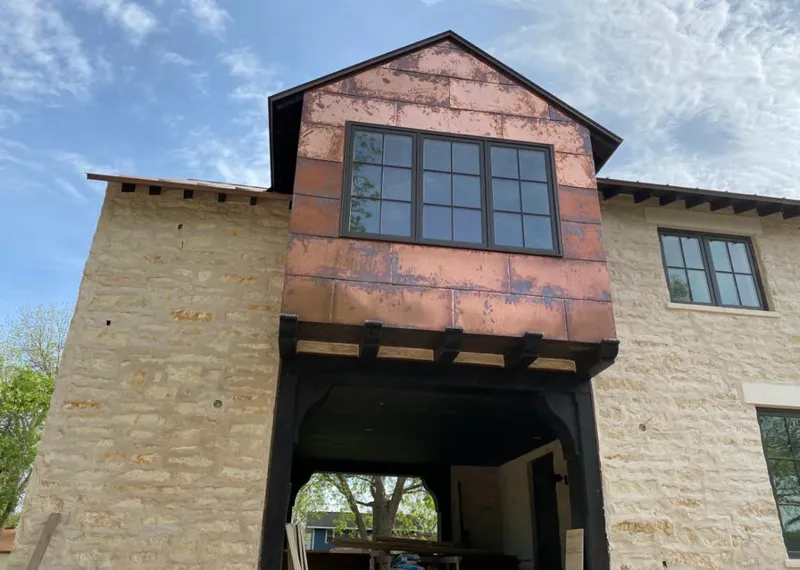 Copper metal panel facade on a stone building for Metal Roof Coating in Ayer